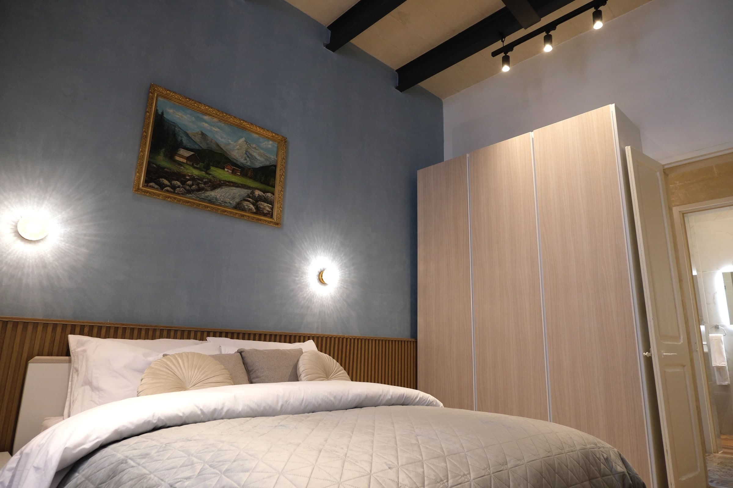 Casa Maria Goretti bedroom with double bed and limestone walls